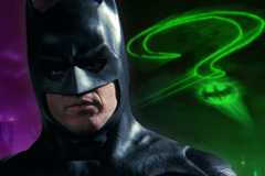 Batman 1989 standing in front of Riddler symbol from Batman Forever