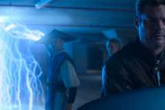 Johnny Cage (Karl Urban) stands in the extreme foreground of a shot as Raiden (Tadanobu Asano) lights up the area with lightning in Mortal Kombat II